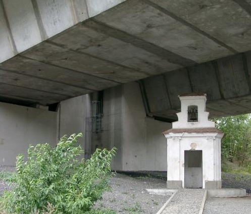 Spending plans for Czech road projects are more than curious - motorway bridging over a chapel in Rehlovice village at the D8 motorway.